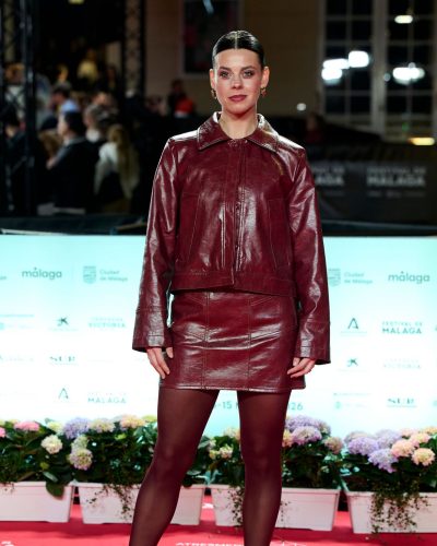 Clara Alvarado in chic burgundy leather attire