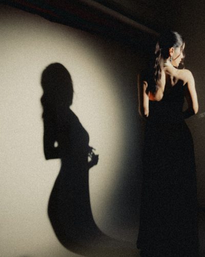 Claudia Coria styled with striking green and blue accessories.