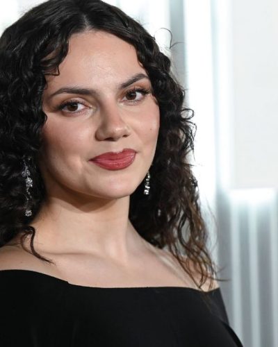 Dafne Keen in chic black gown featuring drop earrings