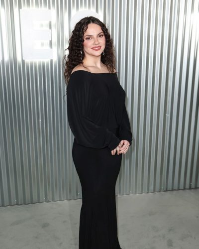 Dafne Keen wearing elegant black gown with flowing fabric