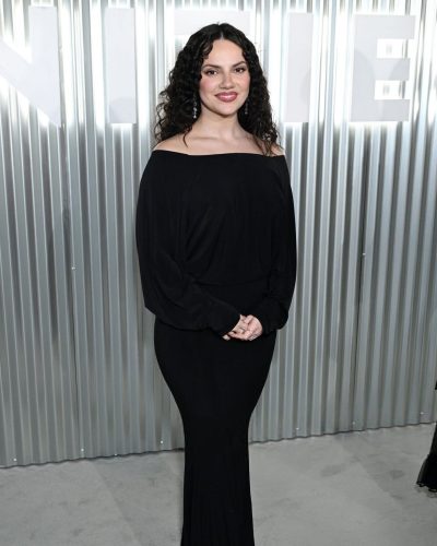 Dafne Keen in black off-the-shoulder gown with long sleeves
