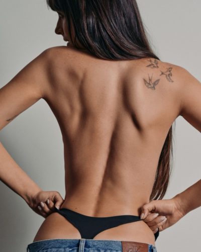 Dakota Johnson wearing black swimwear with a casual touch