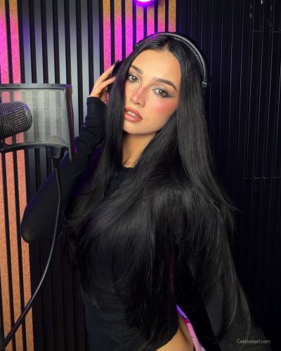 Daria Zaritskaya black sheer long-sleeve top layered with inner wear