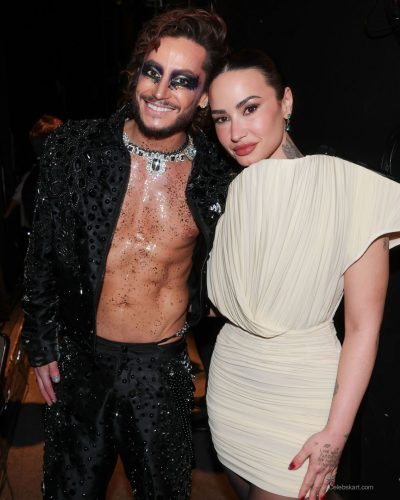 Demi Lovato beautiful cream dress with a snug fit and off-shoulder style