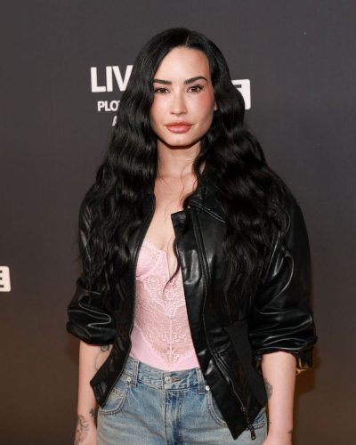 Demi Lovato black leather jacket paired with high-waisted denim shorts.