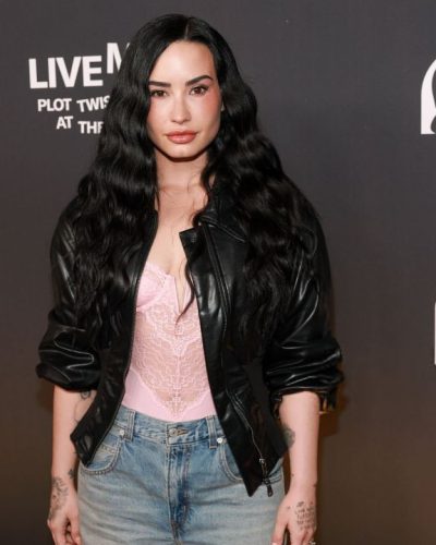 Demi Lovato denim shorts and black leather jacket combination.