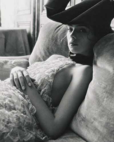 Deva Cassel wearing a flowing floral dress in pastel shades