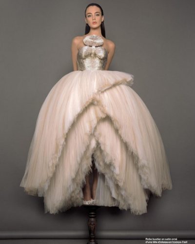 Deva Cassel wearing a white gown featuring a whimsical silhouette.