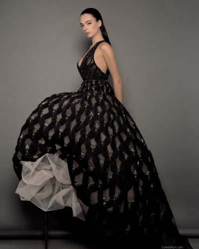 Deva Cassel wearing a white gown with a modern design aesthetic.