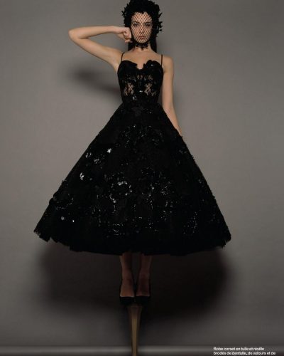 Deva Cassel in a white dress with a graceful flowing skirt.