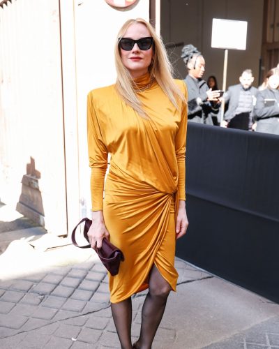 Diane Kruger mustard dress with draped fabric and cinched silhouette