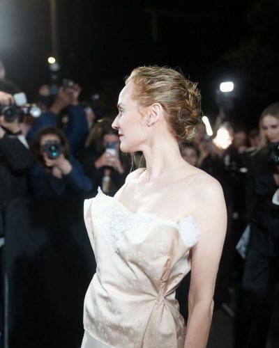 Diane Kruger flowing beige gown with intricate lace neckline