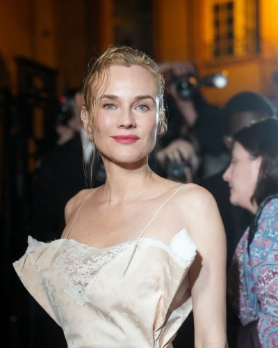 Diane Kruger red handbag adding color to beige gown