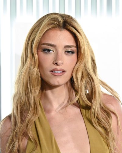 Dixie D’Amelio in a modern beige dress with delicate silhouette.