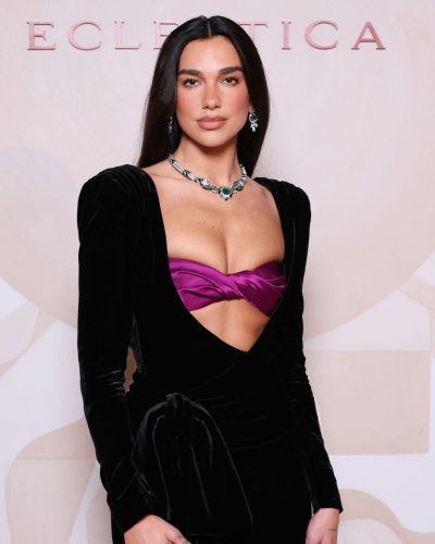 Dua Lipa black gown adorned with sparkling emerald and diamond necklace