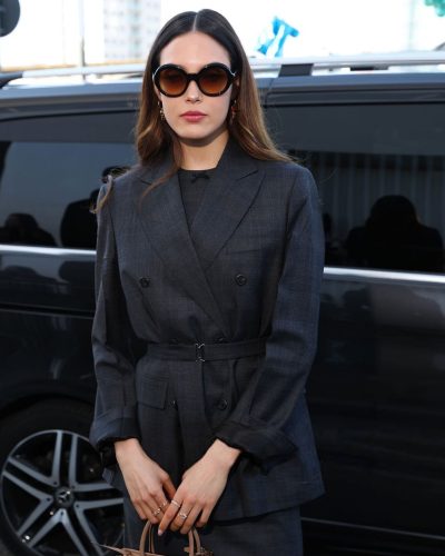 Eileen Gu wearing double-breasted blazer with belted waist.