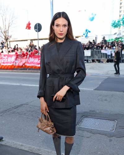 Eileen Gu wearing tailored blazer paired with chic skirt.