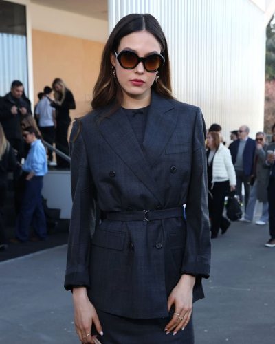 Eileen Gu carrying glossy brown handbag for added sophistication.