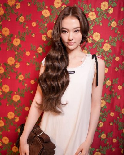 Ella Gross chic white dress with black logo detail.