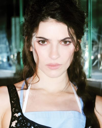 Ella Rubin in a chic green gown with transparent elements