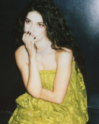 Ella Rubin in a fashionable green lace dress