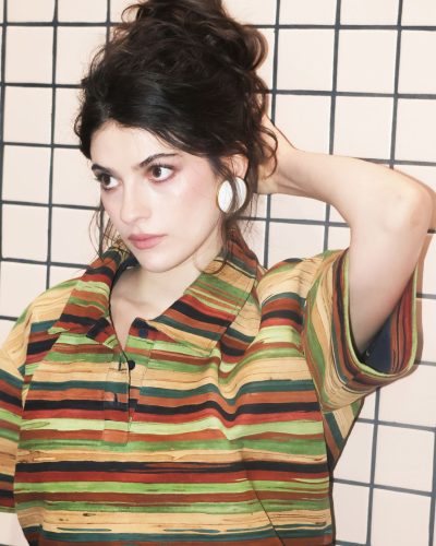 Ella Rubin in a bold green dress with lace details