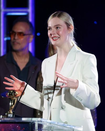 Elle Fanning in white trousers and fitted black top