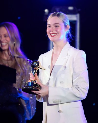 Elle Fanning in white tailored suit with black top