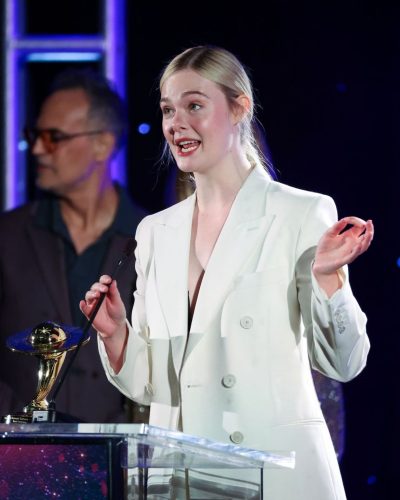 Elle Fanning in tailored white blazer and black shirt