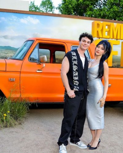 Elliana Walmsley in ribbed silver dress complemented by pink handbag