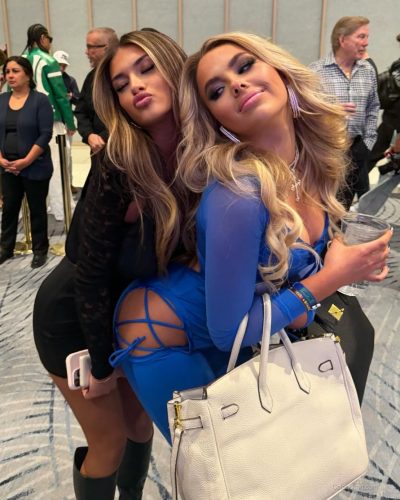 Ellie Blue in a fashionable blue jumpsuit with decorative embellishments