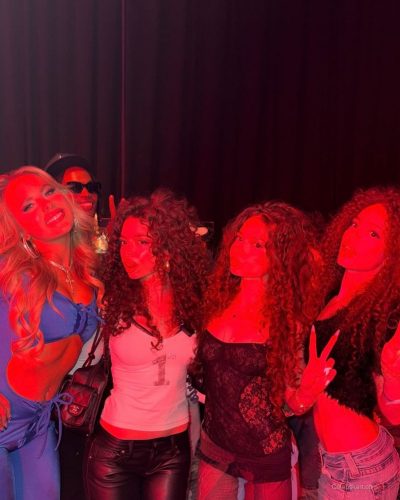 Ellie Blue in a sleek blue bodysuit complemented by chic accessories