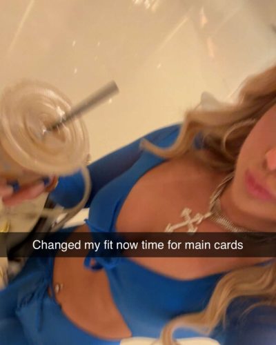 Ellie Blue in a bold blue bodysuit with eye-catching designs