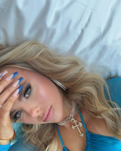 Ellie Blue in blue bodysuit with unique cutouts and embellishments