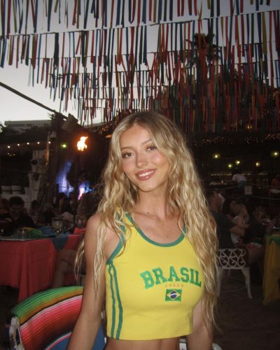 Emily Dobson wearing a chic dress in warm, earthy tones