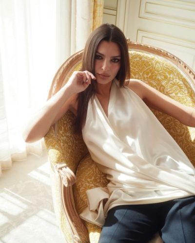 Emily Ratajkowski in a stylish silk blouse and elegant black pants