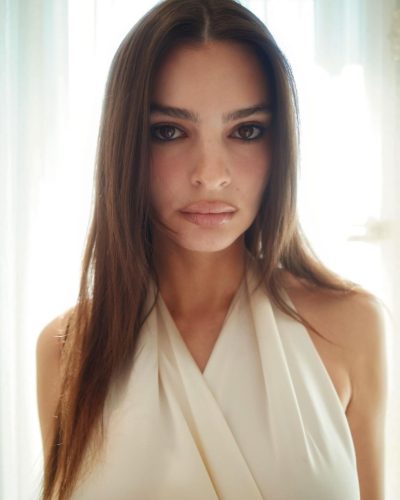 Emily Ratajkowski in a graceful satin top and fitted black slacks