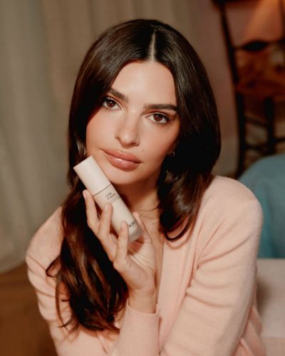 Emily Ratajkowski in pastel cardigan and bright floral gown