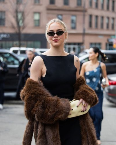 Emma Brooks black fitted dress with brown fur coat