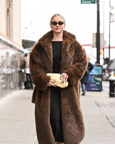 Emma Brooks sleek black dress paired with luxurious fur coat