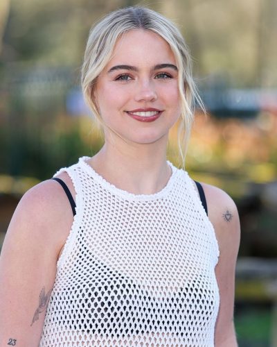 Emma Brooks white mesh top with black high-waisted trousers