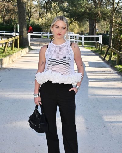 Emma Brooks pointed-toe heels matching black high-waisted trousers