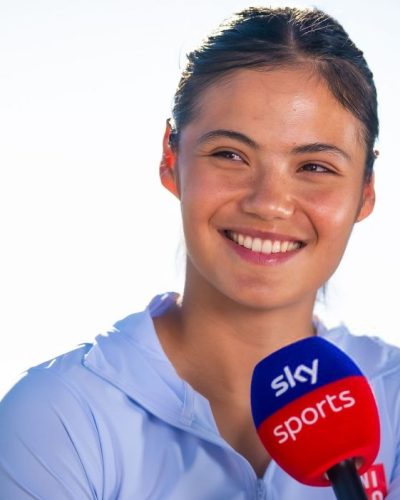 Emma Raducanu wearing casual blue hoodie and sleek hairstyle