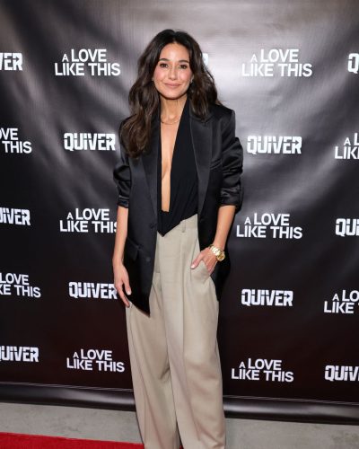 Emmanuelle Chriqui in light-colored trousers and a black blazer.