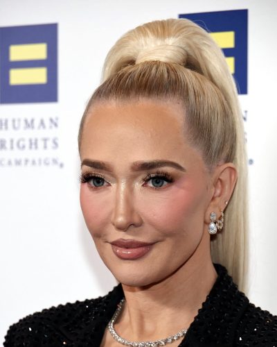 Erika Jayne in polished black suit with captivating makeup.