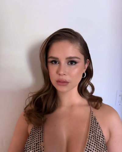 Erin Moriarty in stylish metallic dress featuring a deep neckline