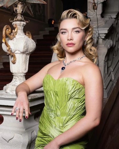 Florence Pugh wearing a green dress with intricate detailing and accessories.