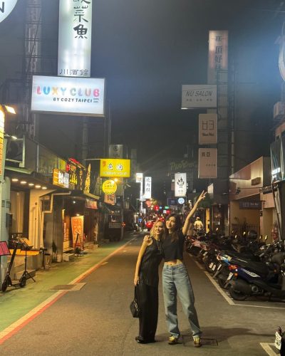 Gemma Chan wearing flowing black gown with modern design.