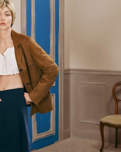 Gigi Hadid dark skirt paired with gray shirt.