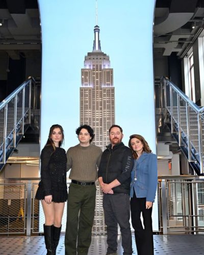 Giorgia Wingham wearing black mini dress paired with knee-high boots